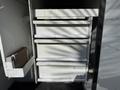 A 2008 Kenworth T370 with an open compartment featuring several metal drawers for storage
