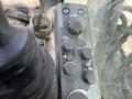 Control panel of a 2018 John Deere 350 featuring knobs and buttons for mode tuning volume and auto settings
