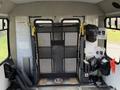 2002 Ford Econoline with a lift installed inside the vehicle for accessibility featuring metal mesh and safety straps attached to the walls