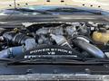 The engine bay of a 2009 Ford F-550 featuring a Power Stroke V8 engine with various components including hoses and an oil reservoir