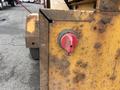 A close-up view of a red power switch labeled OFF on the rusty metal body of a Vermeer Corporation BC1200XL piece of equipment