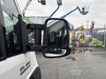 A 2023 RAM Promaster 3500 with a prominent side mirror reflecting its surroundings
