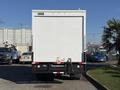 2010 Ford F-450 rear view with a box truck body featuring a white exterior and black bumper with rear lights visible