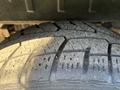Close-up of a worn tire from a 2016 Ford Transit 150 showing visible tread patterns and grooves