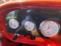 Dashboard of a 1962 Ford 2WHDR featuring three round gauges for volts fuel level and RPM with a carbon fiber accent panel