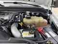 Close-up of the engine compartment of a 2008 Ford F-250 SD featuring the coolant reservoir and various engine components