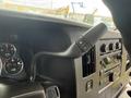 Interior view of a 2013 Chevrolet Express showing the steering wheel controls dashboard gauges and audio system