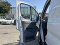 A 2019 Ford Transit 350 van with an open driver's side door showcasing the interior features