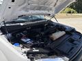 The image shows the engine bay of a 2019 Ford F-150 with various components including the battery and fluid reservoirs visible