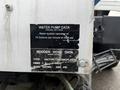 A close-up of a metal plate featuring water pump data for a 2013 International Workstar 7500 with specifications on water system operation and hose ratings