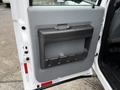 The image shows the interior door panel of a 2016 Ford F-550 Super Duty featuring a gray handle and a storage compartment with vertical dividers