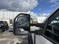 A 2024 Ford F-550 side mirror showing a reflection in the glass