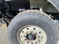 Close-up of a tire on a 2014 International 7400 truck showing tread patterns and lug nuts on a steel wheel