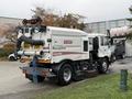 2009 UD Trucks UD 3300 street sweeper with a vacuum system and broom attached on the front side for cleaning road surfaces