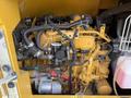 A 2022 Caterpillar 306 engine with various interconnected components including hoses and electrical wiring in a compact arrangement