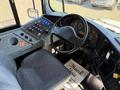 Interior view of a 2013 International CE300 showing the driver's seat dashboard controls and instrumentation
