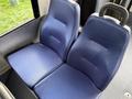 A pair of blue fabric bus seats with a sleek design and a sturdy handle on the backrest