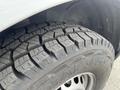 Close-up of a treaded tire from a 2025 Mercedes-Benz Sprinter showcasing its rugged design and deep grooves for traction