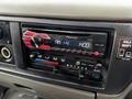 A Pioneer car stereo with a digital display showing AM radio and temperature controls located in the dashboard of a 2009 UD Trucks UD 3300