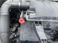 Close-up of the engine compartment of a 2022 Mercedes-Benz Sprinter showing various components and a red cap on top of the engine part