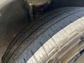 Close-up of the tire of a 2023 Fisker Ocean showcasing the tread pattern and sidewall details