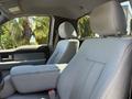 Interior of a 2014 Ford F-150 showing gray fabric seats with a center console and headrests