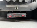 Control panel with labeled switches and indicators for a 2012 International DuraStar 4300 featuring two red buttons labeled OFF and an arrow symbol