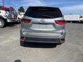 A silver 2018 Toyota Highlander viewed from the rear with a missing license plate and visible tail lights