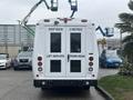 A white 2021 Ford Transit-350 with signage reading Keep Back 5 Metres Lift Deploys From Rear and large doors at the rear