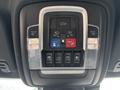 Overhead control panel of a 2021 RAM 1500 featuring buttons for assist, tilting, venting, and opening windows with indicator lights