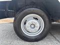 Close-up of a tire and wheel of a 2018 Ford Econoline showing a silver rim with six bolts and a black Michelin tire