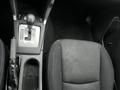 2016 Subaru Forester interior showing gear shift console and driver seat with black fabric upholstery