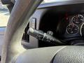Close-up of the steering column of a 2017 Chevrolet Express showing the windshield wiper control stalk and dashboard gauges