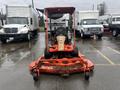 A 2010 Kubota F3680 lawn mower with a front-mounted mower deck is positioned in a parking lot showcasing its orange body and simple control panel