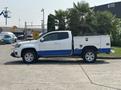 A 2017 Chevrolet Colorado with a white and blue exterior features a utility bed and chrome wheels