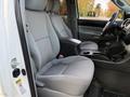 Interior of a 2013 Toyota Tacoma showing front seats in gray fabric with a center console between them