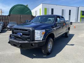 A dark blue 2016 Ford F-250 SD pickup truck with a black front bumper and large tires parked in a lot
