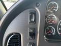 Close-up of a control panel featuring buttons for speed control cruise control and gauges for oil water and transmission levels in a 2019 Freightliner M2 106