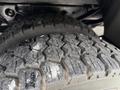 Close-up view of a heavily treaded tire on a 2007 Ford F-550 showing detailed tire patterns and wear on the rubber surface