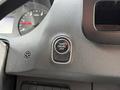 A close-up view of the engine start-stop button in a 2022 Mercedes-Benz Sprinter with a sleek design and a circular shape