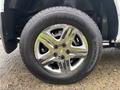 A close-up view of a chrome alloy wheel with a General Altimax tire on a 2011 Chevrolet Colorado
