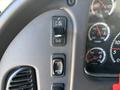 The control panel of a 2005 Freightliner M2 106 featuring switches for lights and an increase-decrease control knob for settings