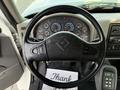 The steering wheel of a 2011 International 7500 with various dashboard gauges visible and a note reading Thank on the floor beneath