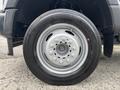 Close-up of a 2023 Ford F-450 Super Duty wheel featuring a silver rim and black tire with visible tread patterns