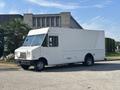 A white 2012 Ford E-450 box truck parked with a clean exterior and large cargo area designed for commercial use