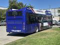 A 2018 Grande West Vicinity transit bus in blue and white with a clean air vehicle label parked at a location