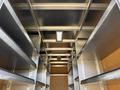 A 2016 Ford Transit cargo van interior featuring metal shelving and a light fixture on the ceiling