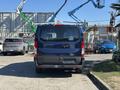 A blue 2016 Ford Transit 150 van viewed from the rear with a roof rack and no visible license plate