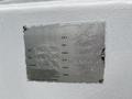 A metallic identification plate from a 2013 Freightliner 114SD displaying job number OEM model serial number and inspection details