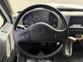 Steering wheel and dashboard of a 2011 International 4300 displaying various gauges and controls